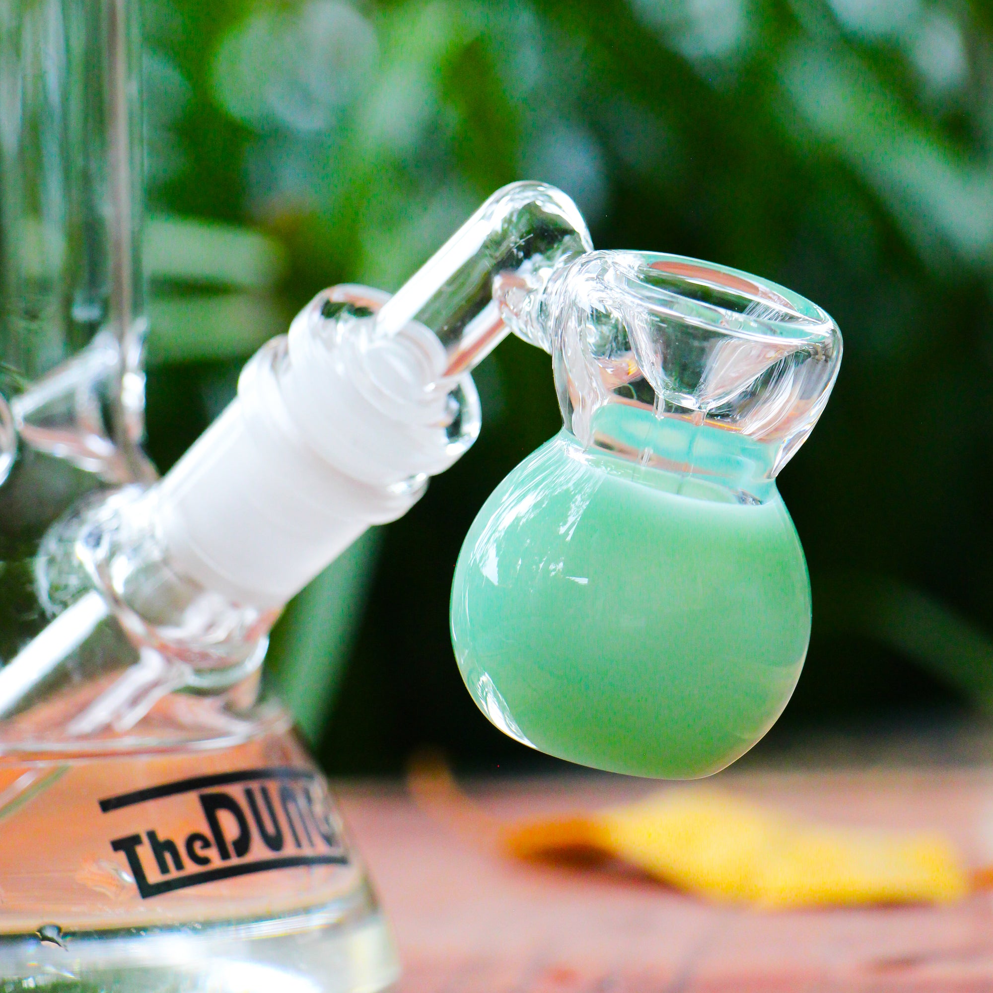 the dung 14mm aqua mini perc ash catcher in a chronical bong in a garden