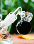 the dung 14mm black mini perc ash catcher in a chronical bong in a garden