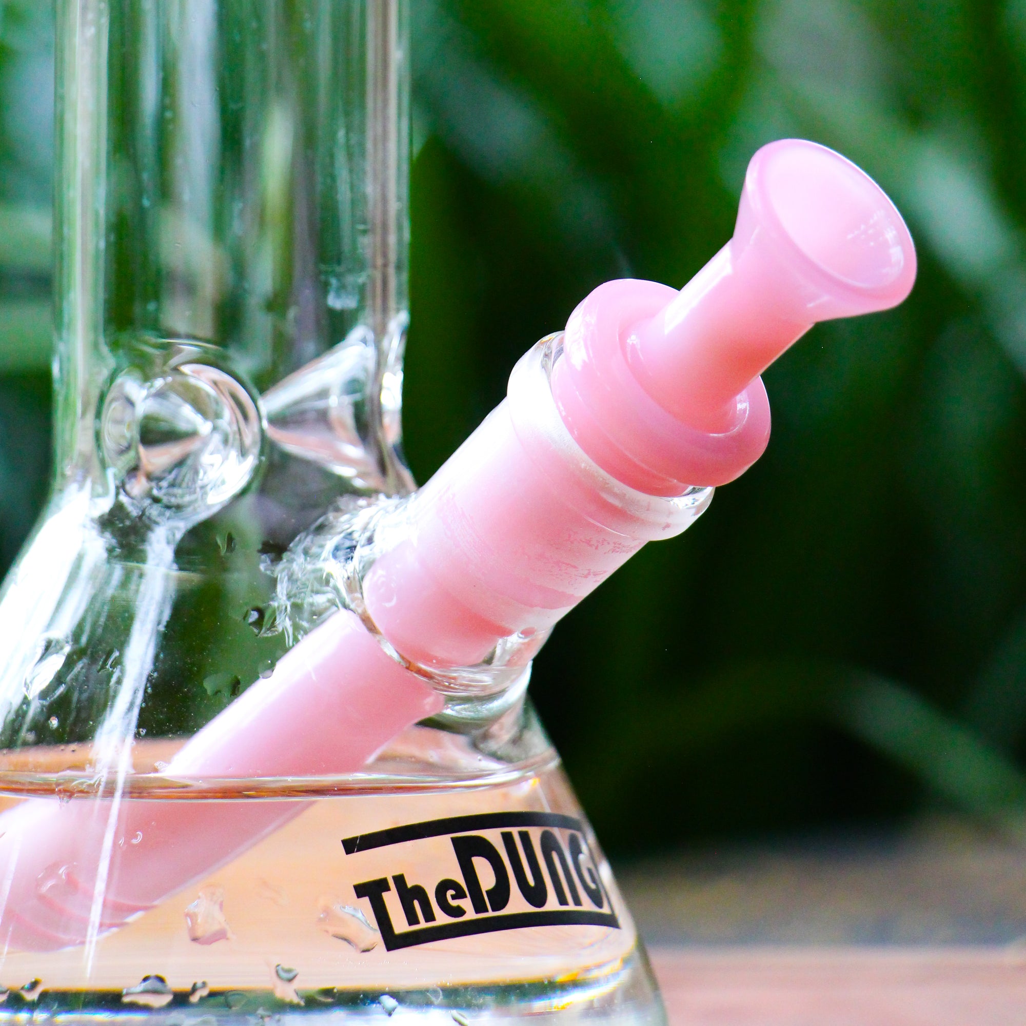 The Dung milky pink cone piece in a The Dung chronical bong in a garden