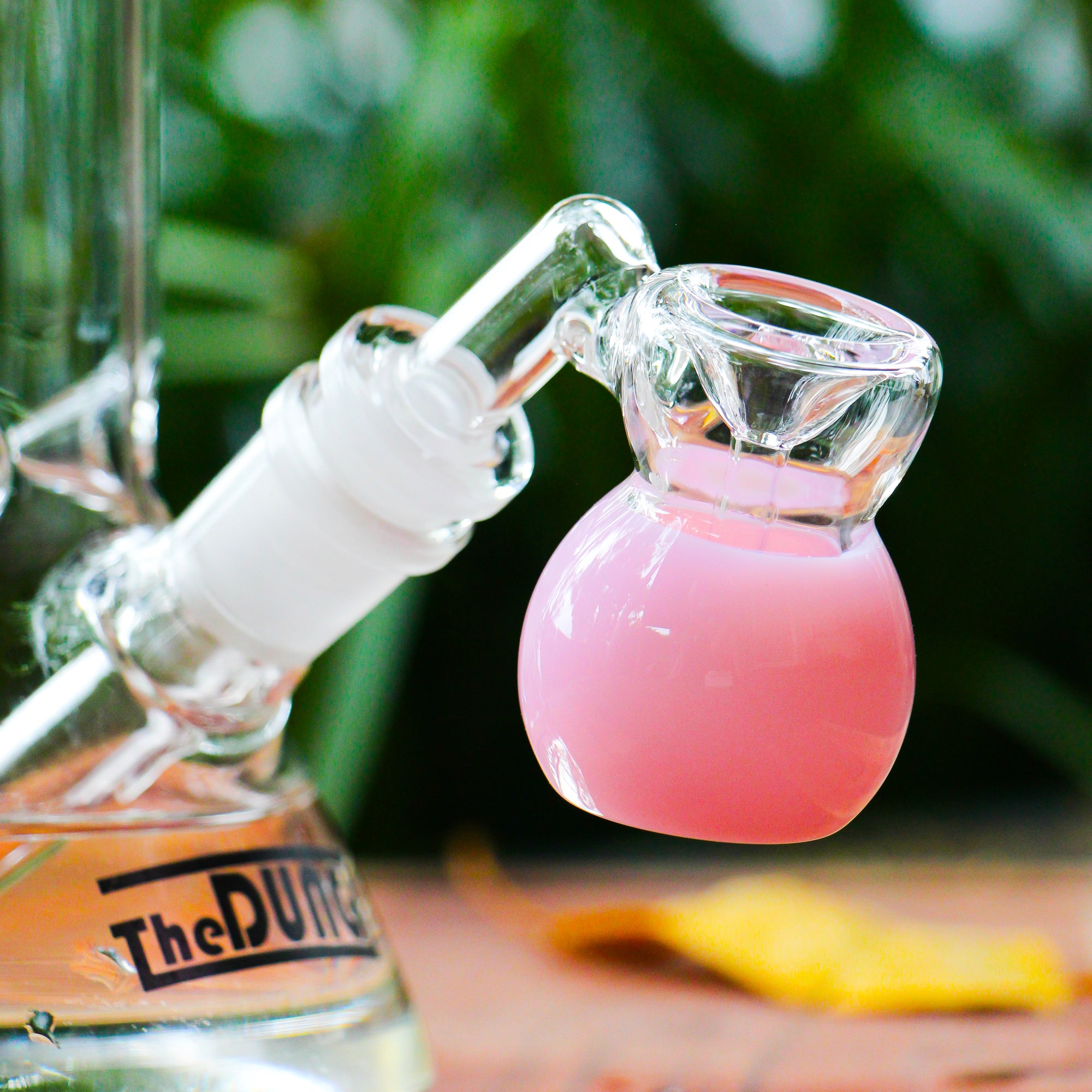 the dung 14mm milky pink mini perc ash catcher in a chronical bong in a garden