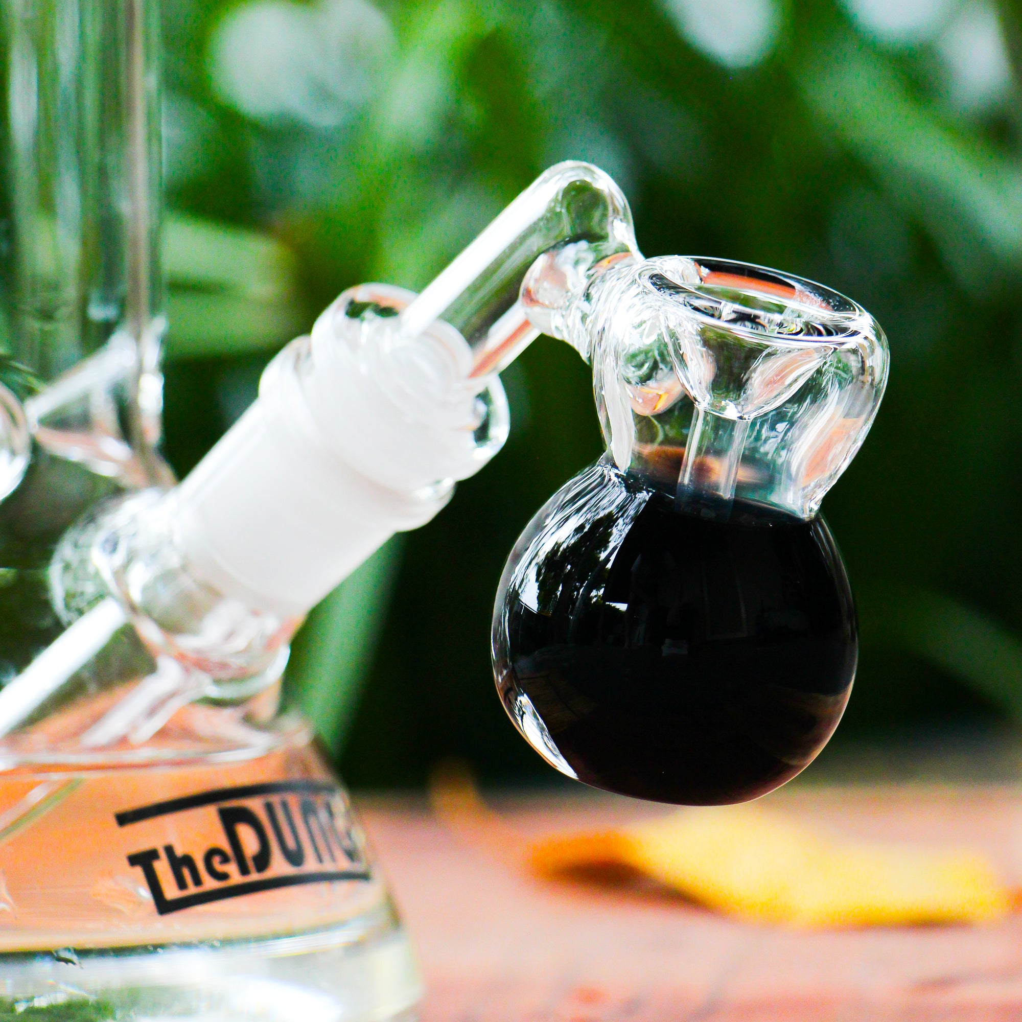 the dung 14mm black mini perc ash catcher in a chronical bong in a garden