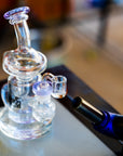 the dung recycler dab rig being heated up with a jet torch on top of a dab mat